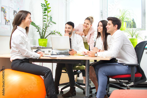 Group of young business people having meeting in modern office.