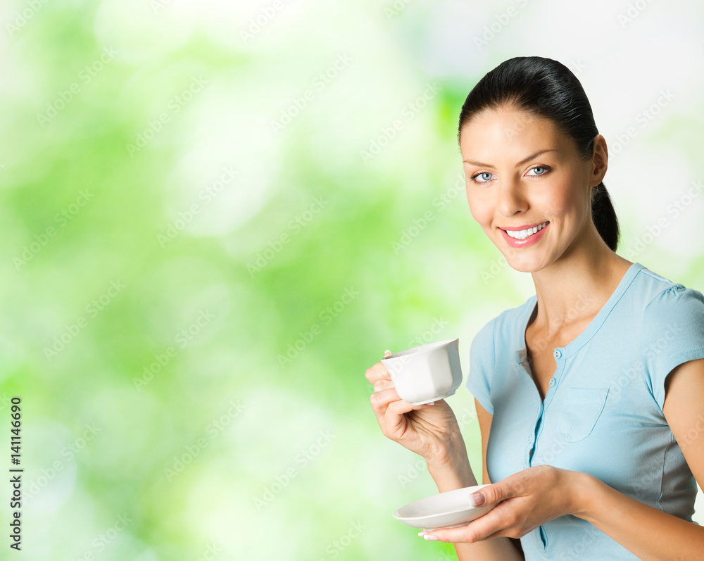 Young happy woman drinking coffee, outdoors Young happy woman drinking coffee, outdoors