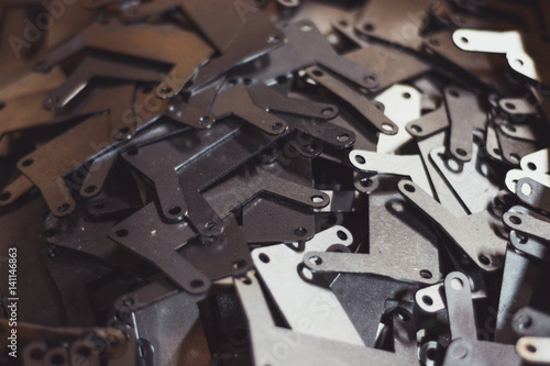 Laser cut steel parts. Steel metal cut into small parts with holes by laser cutting machine.