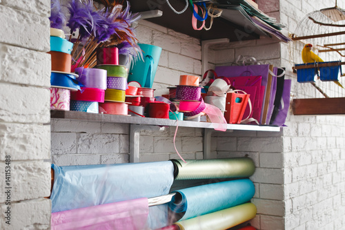 multicolored rolls with ribbons on the shelves