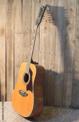 Guitar leaning against a wall