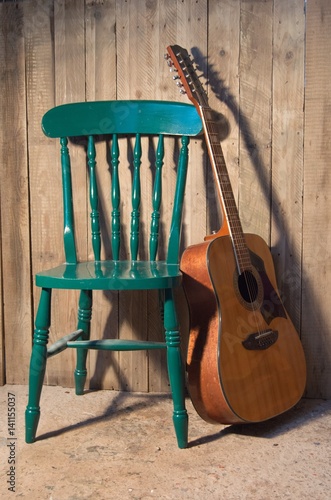 Guitar leaning against a chair