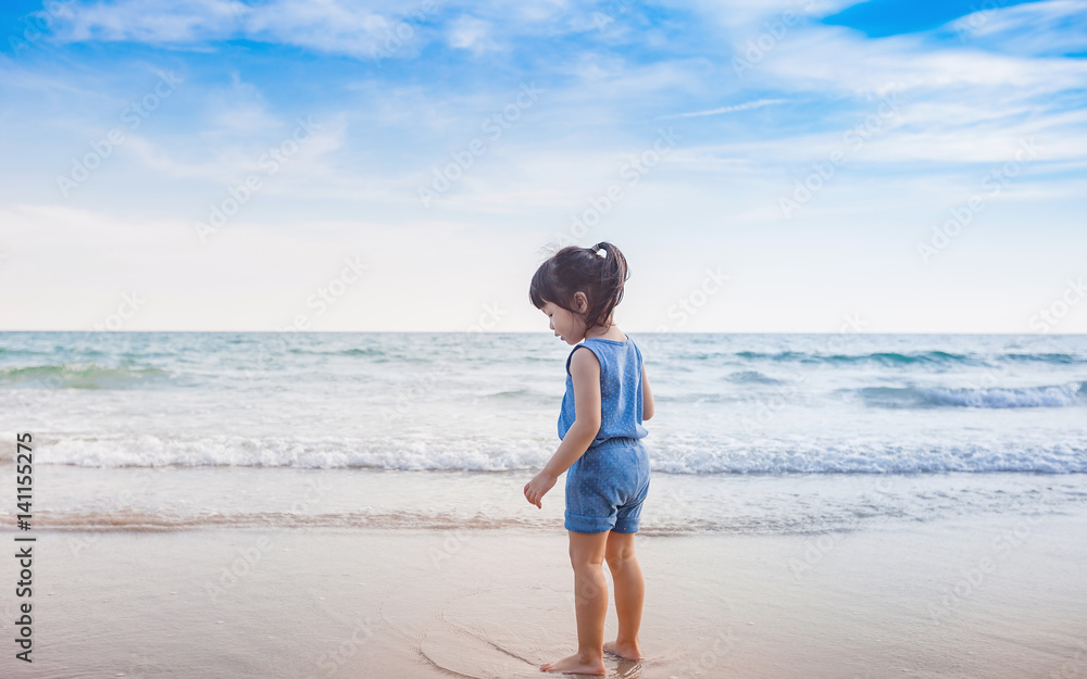 little girl playing on the beach in sunset little girl playing on the beach in sunset