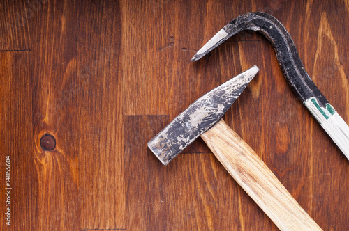 Hammer and nail puller on a table. Old tools