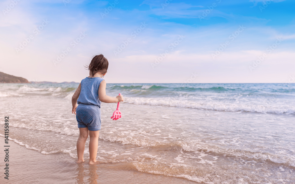 little girl playing on the beach in sunset Stock Photo | Adobe Stock