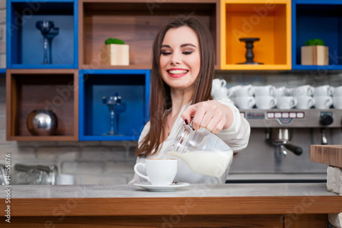 young girl preparing coffee in a cafe barista