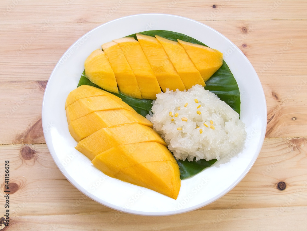 Mango sticky rice. Thai style dessert, mango with glutinous rice on wooden table background.