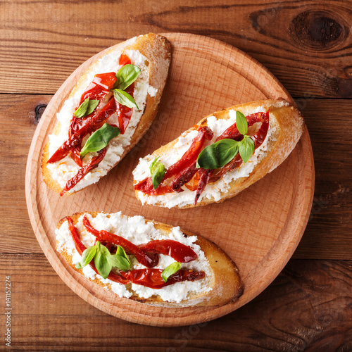 Italian sandwiches - bruschetta with cheese, tomato and basil. Top view