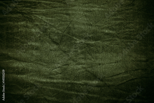 Texture of dark khaki crumpled fabric photo