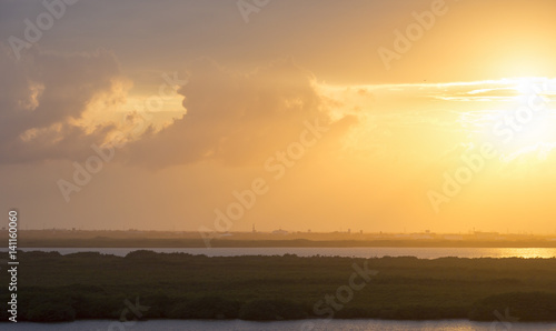 Yellow sky. Sunset over the Caribbean coast. Image taken from high level. Beautiful wallpaper.