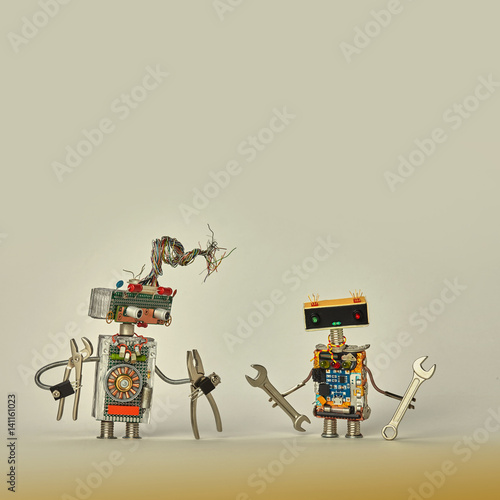 Construction workers service. Creative design toy robots with pliers hand wrench in arms. Colorful characters, wires, electronic circuit, chip capacitors resistors. Beige paper background copy space