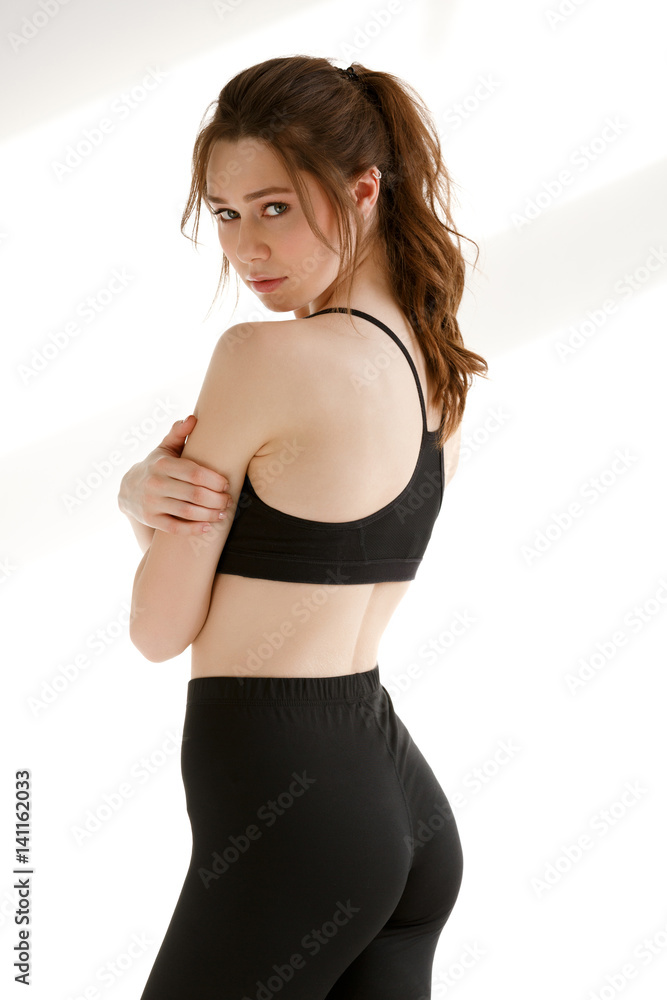 Incredible sports lady posing over white background.