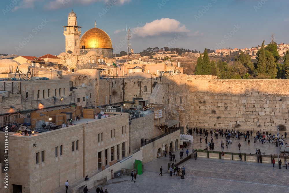 Sunset at Temple Mount in the old city of Jerusalem, including the Western Wall and golden Dome of the Rock,
