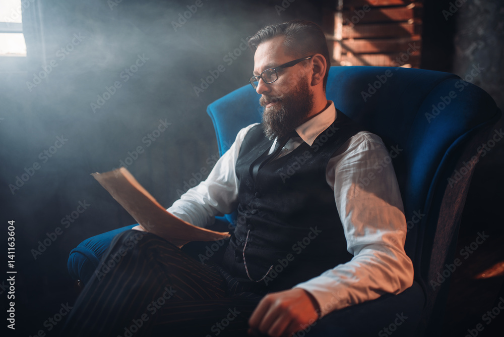 Bearded writer in glasses reads handwritten text Bearded writer in glasses reads handwritten text