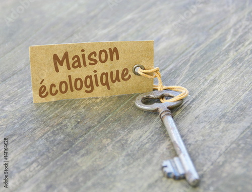 maison écologique sur étiquette ,sur clé et fond bois photo