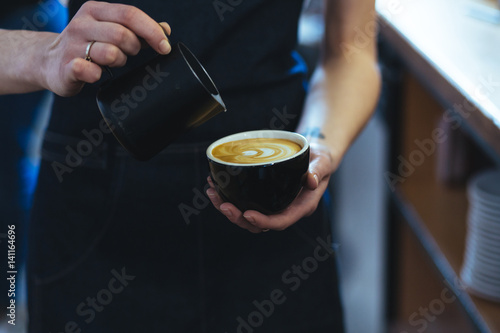 Barista making fresh coffee capuccino. Coffee Preparation Service Concept