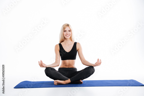 Happy fitness woman sitting make yoga exercises