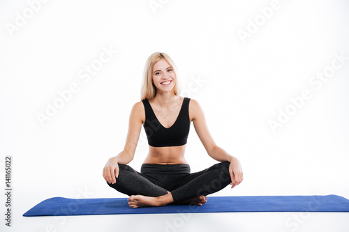 Happy fitness woman sitting make yoga exercises