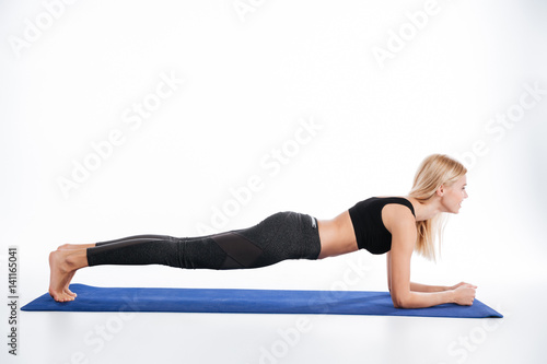 Concentrated fitness woman make sport exercises plank