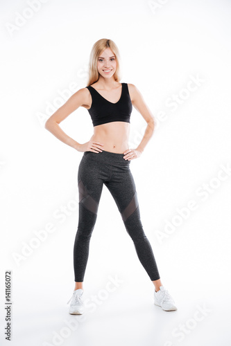 Cheerful pretty fitness woman standing and posing