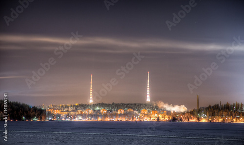 Two radio towers on top of the hill