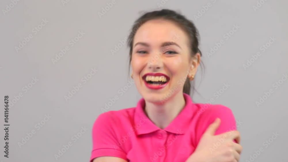 Attractive young woman happy. Beautiful young female model in pink polo. Attractive young woman happy. Beautiful young female model in pink polo.