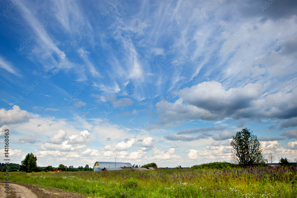 Blue sky with beautiful bizarre clouds in the countryside Blue sky with beautiful bizarre clouds in the countryside