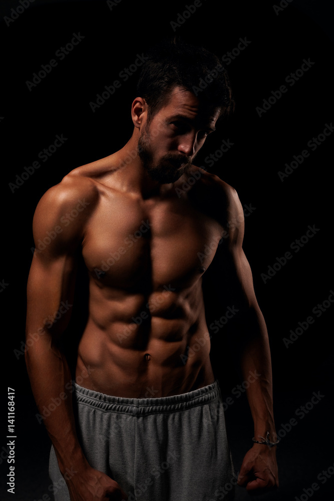 Attractive shirtless man showing his six pack