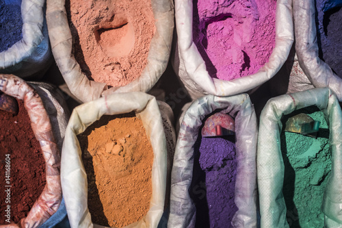 Morocco, Chechaouen. Containers of colorful pigments, powders or dyes on historical village street. photo