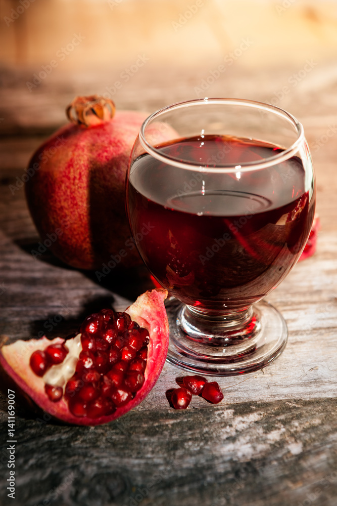 Delicious juice from ripe pomegranate in glass Delicious juice from ripe pomegranate in glass