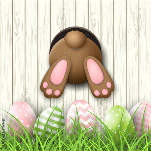 Easter motive, bunny bottom andeaster eggs in fresh grass on white wooden background, illustration