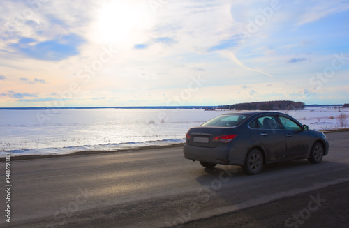 car goes on the road lake in winter © Yuri Bizgaimer
