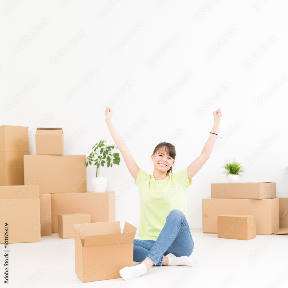 Young happy woman, a student, moved into a new apartment. Young happy woman, a student, moved into a new apartment.