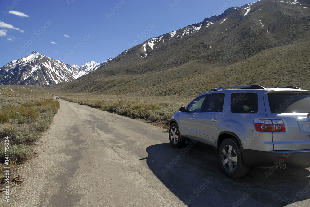 Dirt Road into the Mountains with SUV vehicle