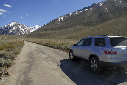 Dirt Road into the Mountains with SUV vehicle © nyker