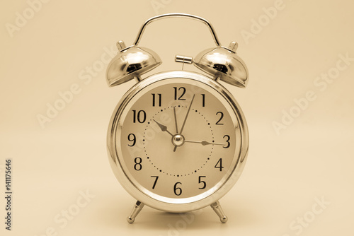 alarm clock retro and vintage classic design in sepia tone background