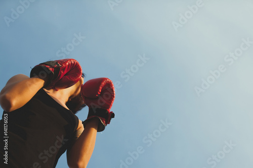 Young adult woman doing kickboxing training with her coach. Sport, fitness, lifestyle and people concept.
