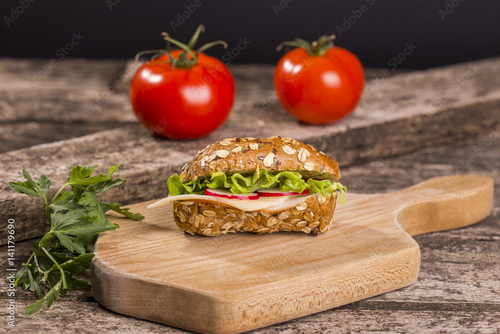 Healthy sandwich made with whole grain bread, lettuce, tomato, radish, cheese and roasted chicken slices. Healthy sandwich made with whole grain bread, lettuce, tomato, radish, cheese and roasted chicken slices.