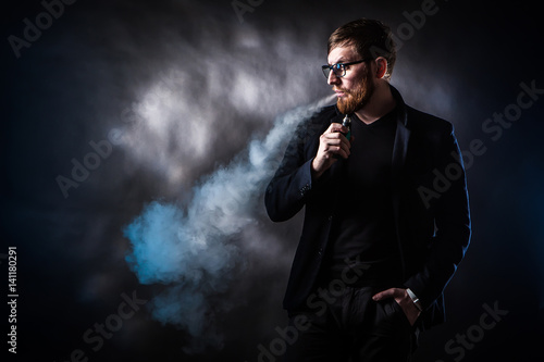 The man releases smoke. E-c...