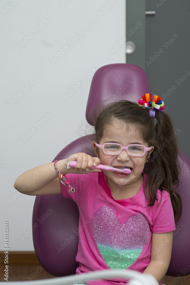 Portrait of little girl wearing sunglasses brushing teeth Portrait of little girl wearing sunglasses brushing teeth