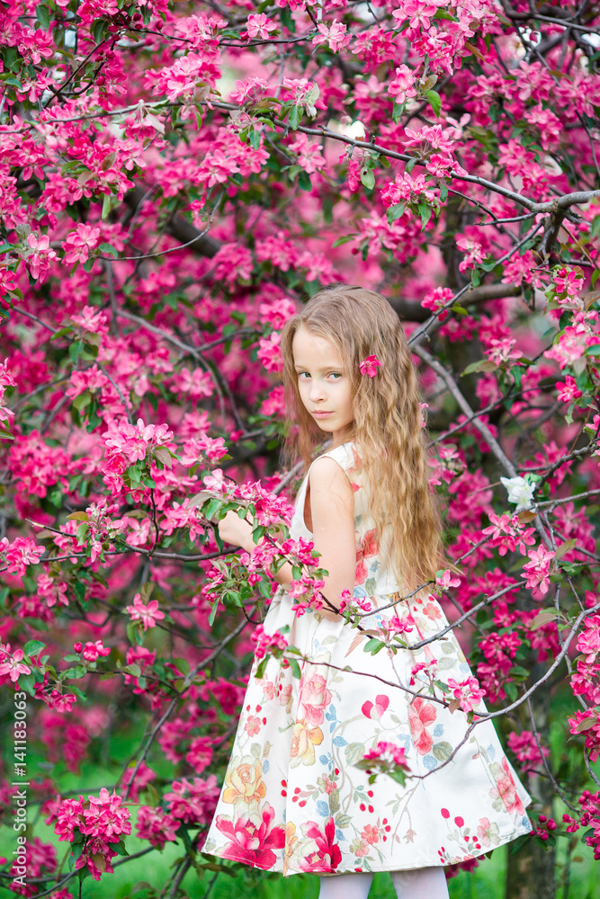 Little girl in blooming apple tree garden enjoy spring Little girl in blooming apple tree garden enjoy spring