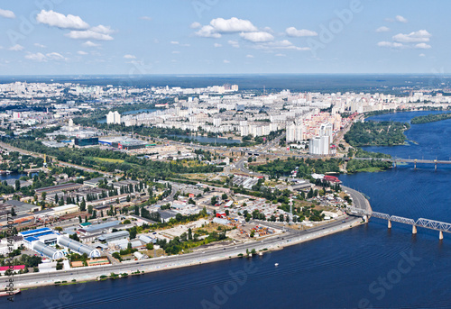 Aerial view of the Kiev (Kyiv) city, Ukraine. Dnieper river with bridges. Obolon district in the background