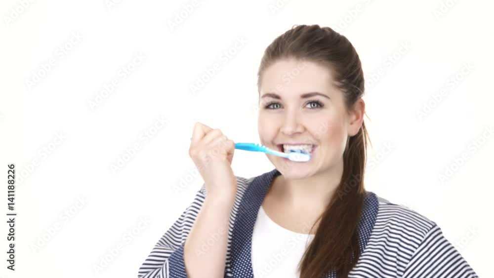 Woman dark long hair brushing cleaning teeth. Positive girl with toothbrush. Oral hygiene. Studio shot isolated on white background 4K ProRes HQ codec Woman dark long hair brushing cleaning teeth. Positive girl with toothbrush. Oral hygiene. Studio shot isolated on white background 4K ProRes HQ codec