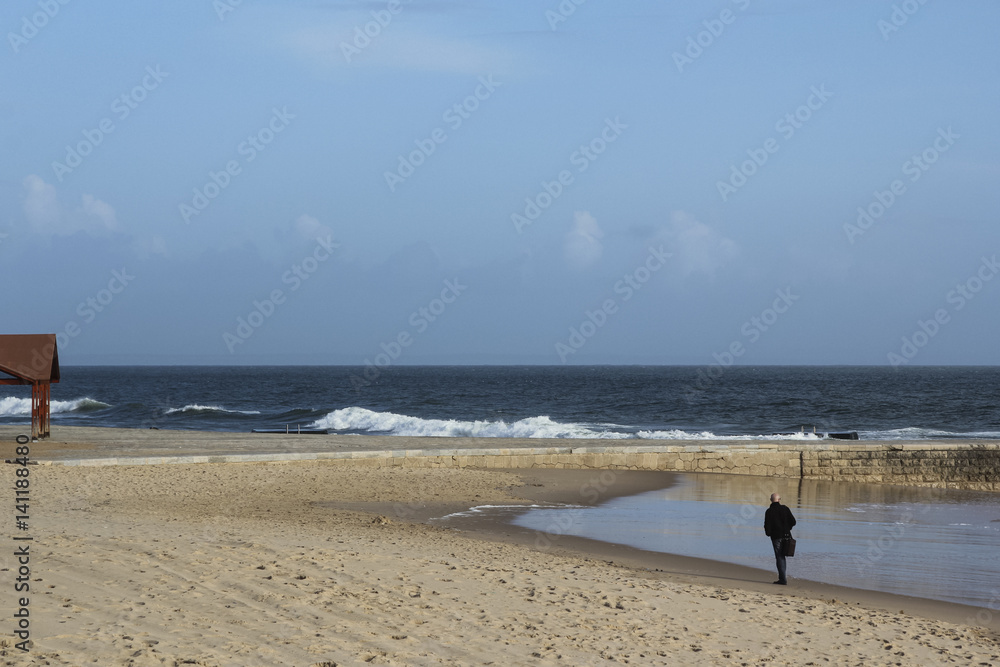 Businessman is rambling along the shore in Estoril, Portugal