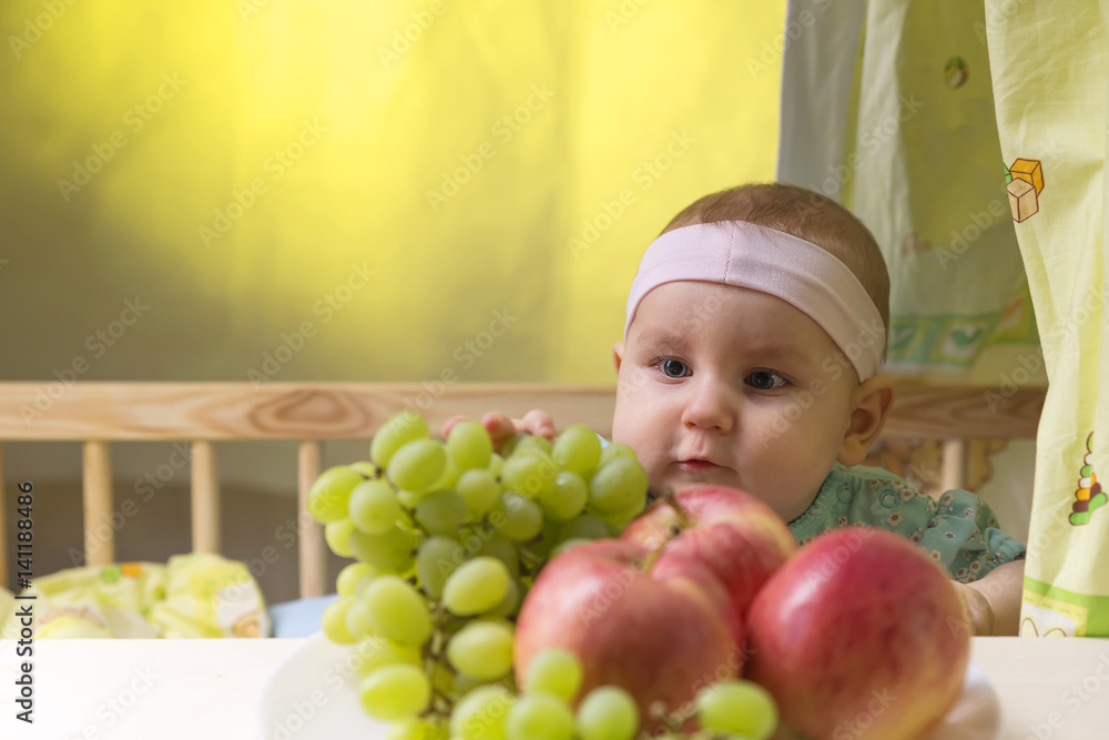 dear small emotional child near a fresh fruits dear small emotional child near a fresh fruits