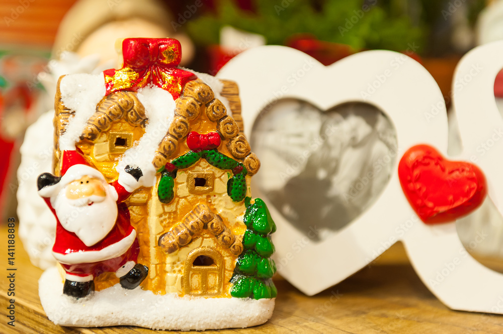 Heart shaped photo frame on wood table Against the background of Christmas toys