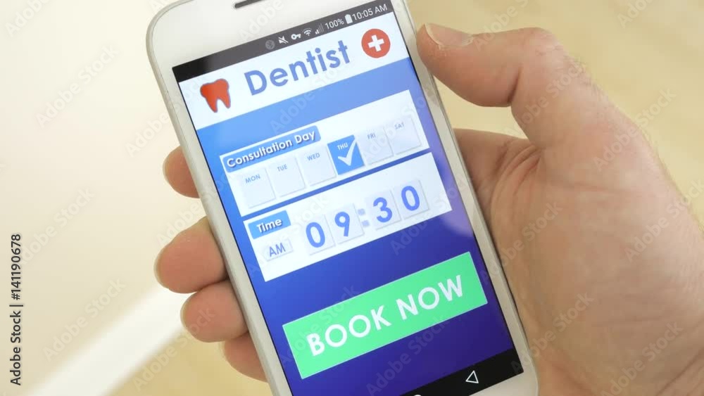 Using a smartphone to book a dentist appointment using an application. Using a smartphone to book a dentist appointment using an application.