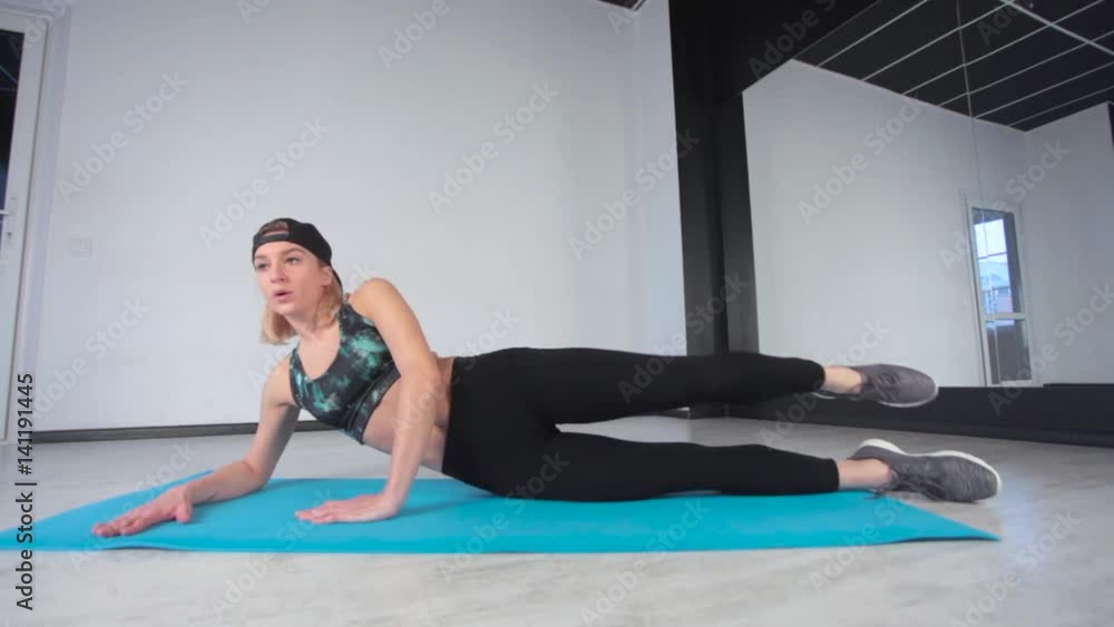 fitness. sport, training and lifestyle concept - woman doing exercises on mat in gym fitness. sport, training and lifestyle concept - woman doing exercises on mat in gym