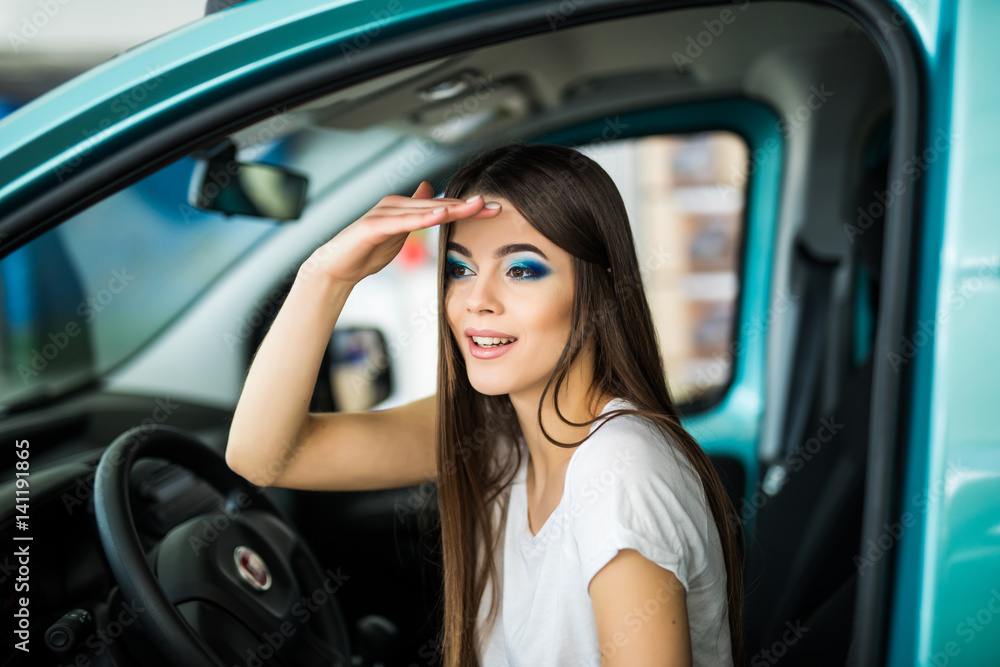 Young woman gesturing while seat in car. looking for.