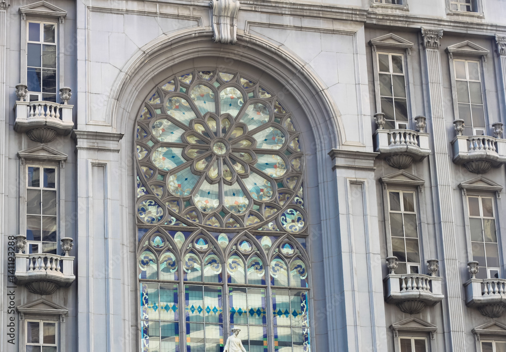 beautiful stained glass window on classical european style building with church facade